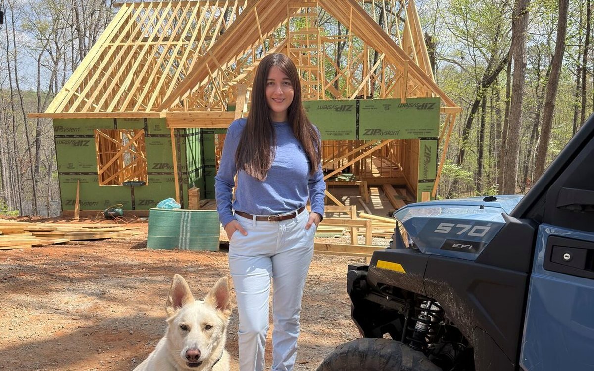 América Ahumada frente a una casa en estructura, obra propia en Carolina del Sur